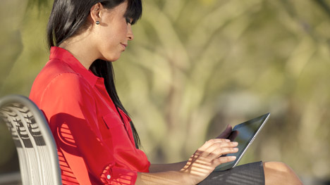 Photo of a woman reading on a tablet