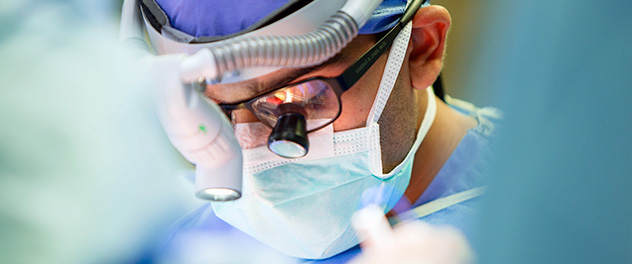 Surgeon wearing special magnifying lens