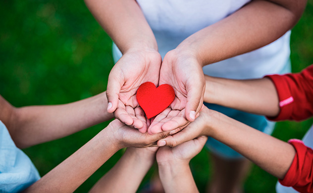 Children holding a heart.