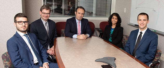 Members of Dr. Savica's research team sitting around a conference table