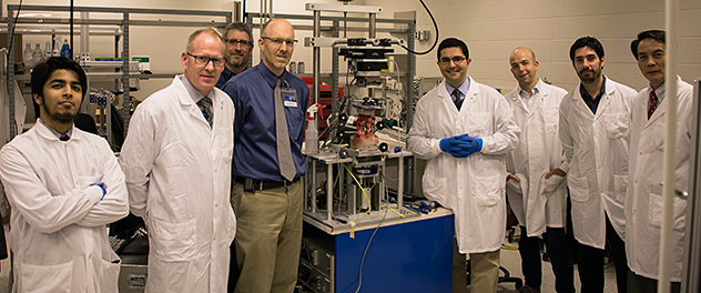 Neuro-Informatics Lab researchers pose for a photo next equipment from the biomechanics team.