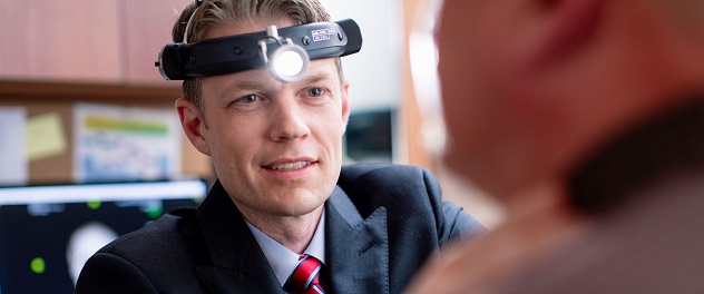 Dr. Michael Olson examines a patient in the sleep apnea surgery clinic.