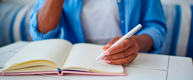 Person writing in notebook