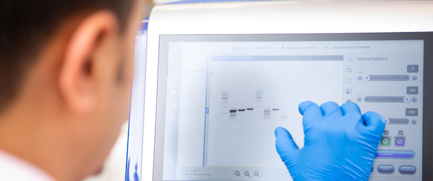 Lab member using a touchscreen on lab equipment