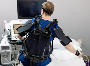 Cardiac sonographer simulates right-handed exoskeleton testing on repetitive tasks.