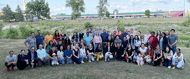 Staff members of the Department of Biochemistry and Molecular Biology gather for a group photograph at a picnic.