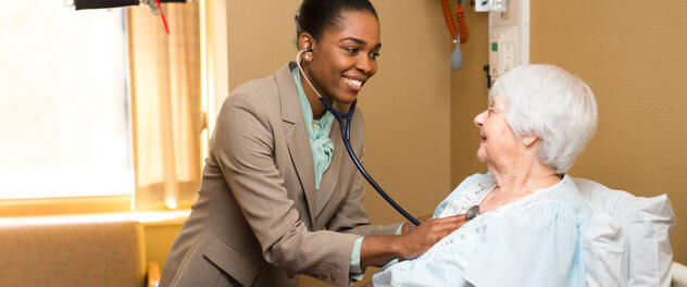 A female doctor examining a female patient.